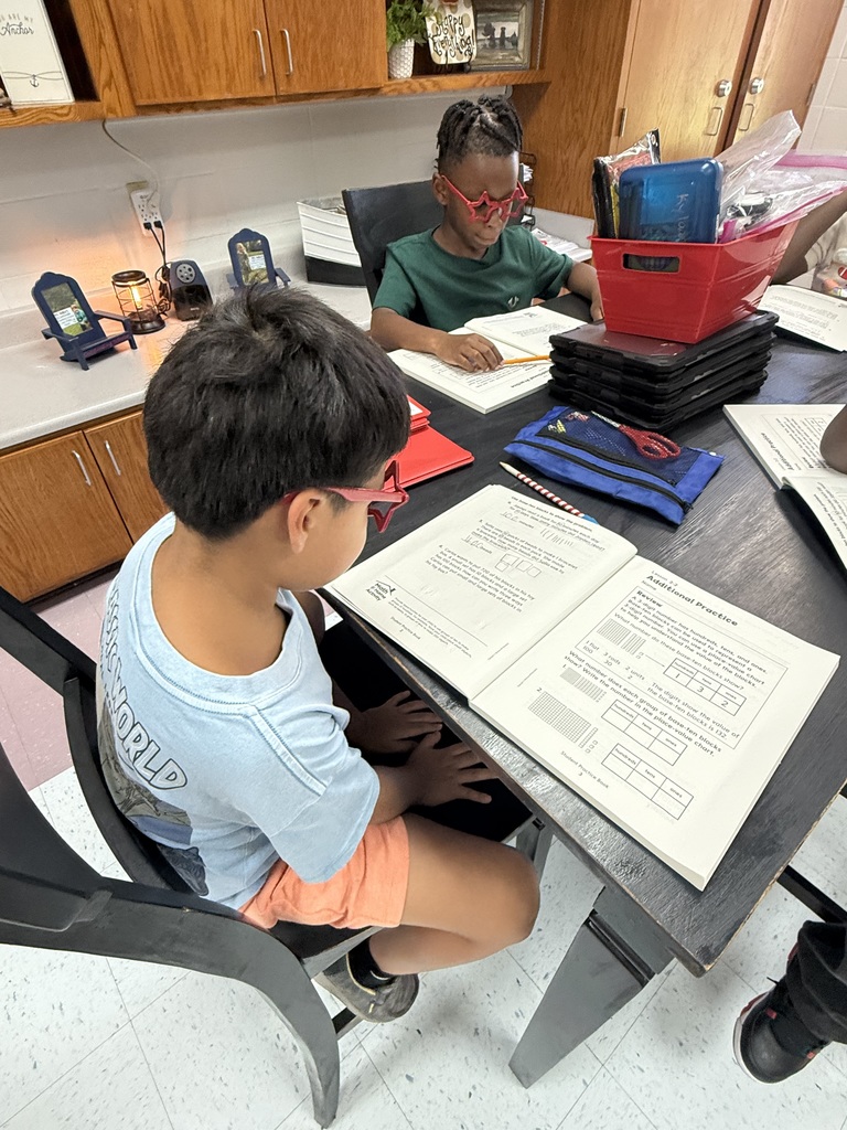 Students sitting at table in classroom.