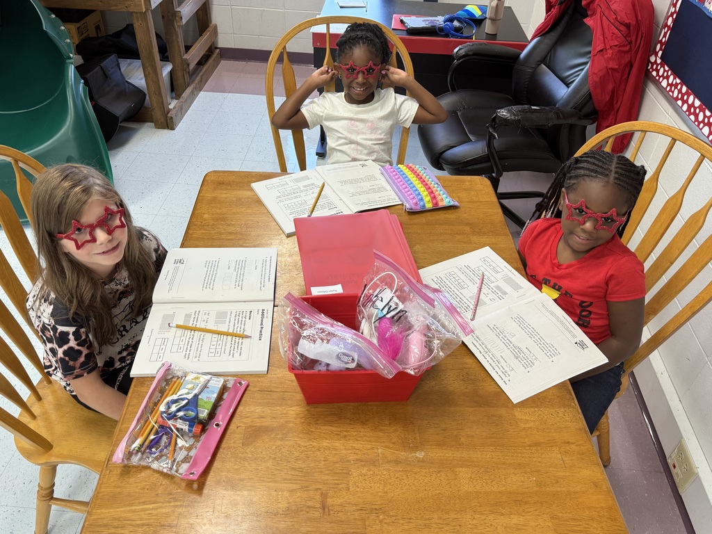Students sitting at table in classroom.
