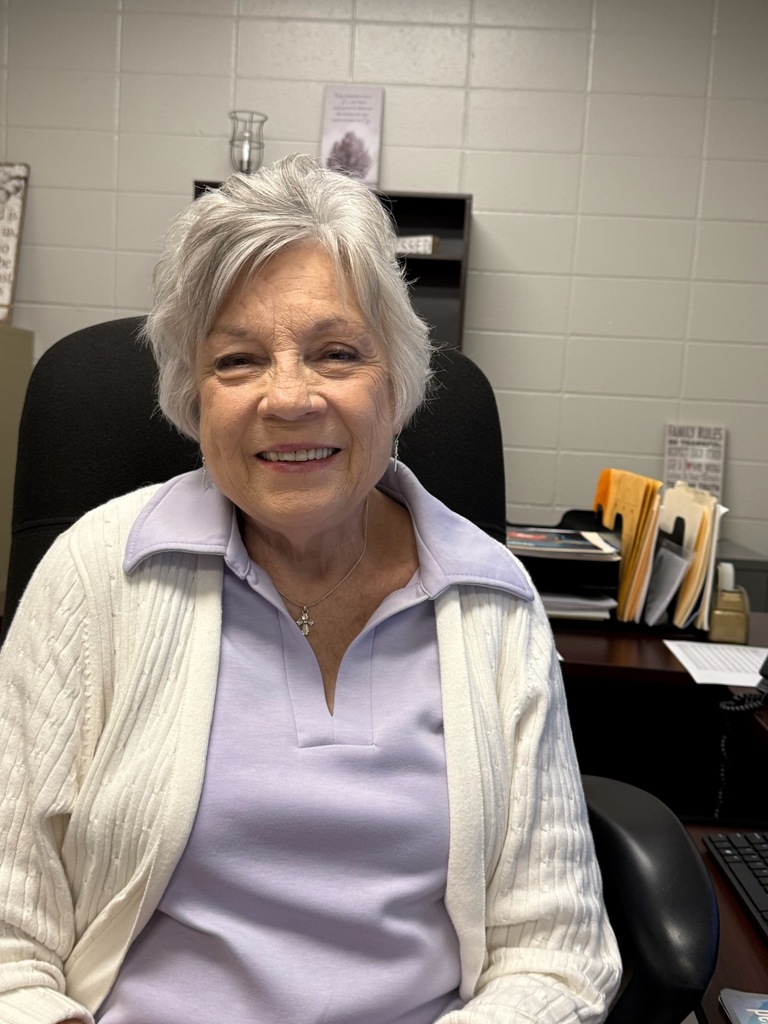 Portrait of an individual wearing spirited purple and gold Bearcat attire. The background varies, including office and home settings with decorative and school-related items visible.