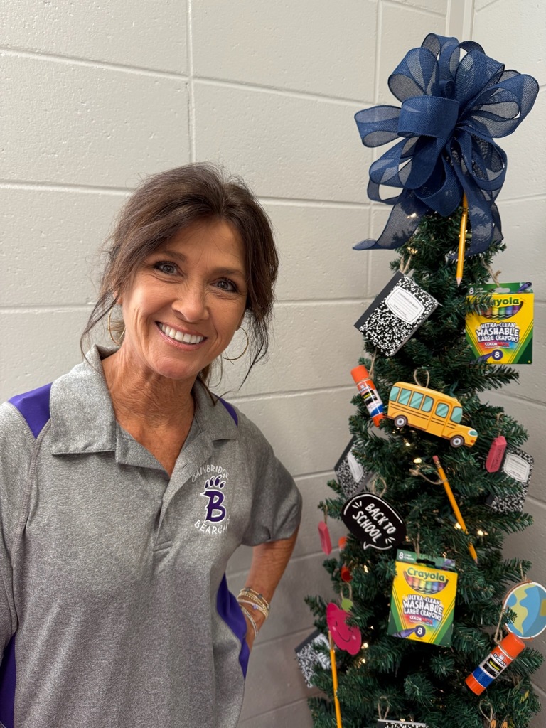 Portrait of an individual wearing spirited purple and gold Bearcat attire. The background varies, including office and home settings with decorative and school-related items visible.