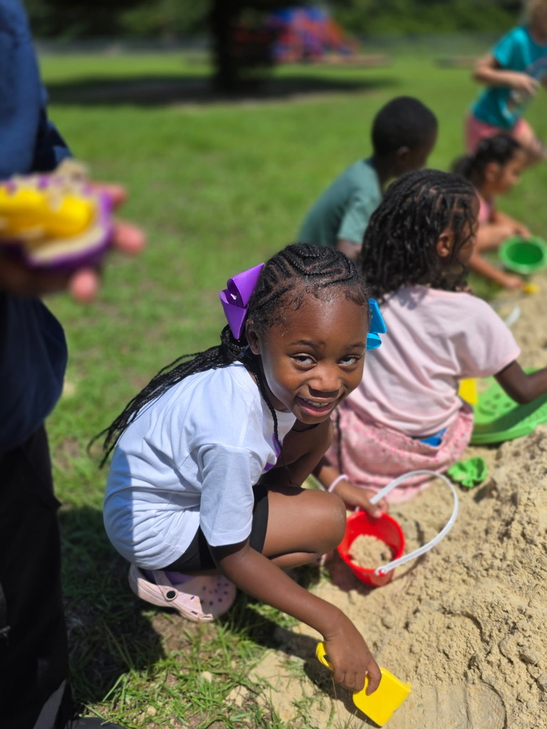 Students playing in the sand.