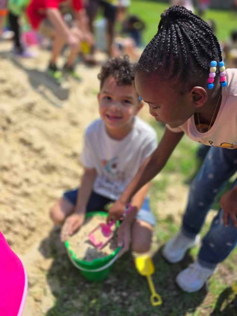 Students playing in the sand.