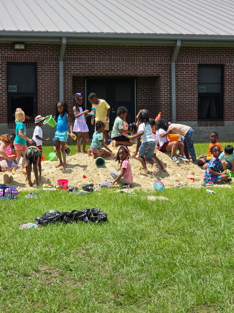 Students playing in the sand.