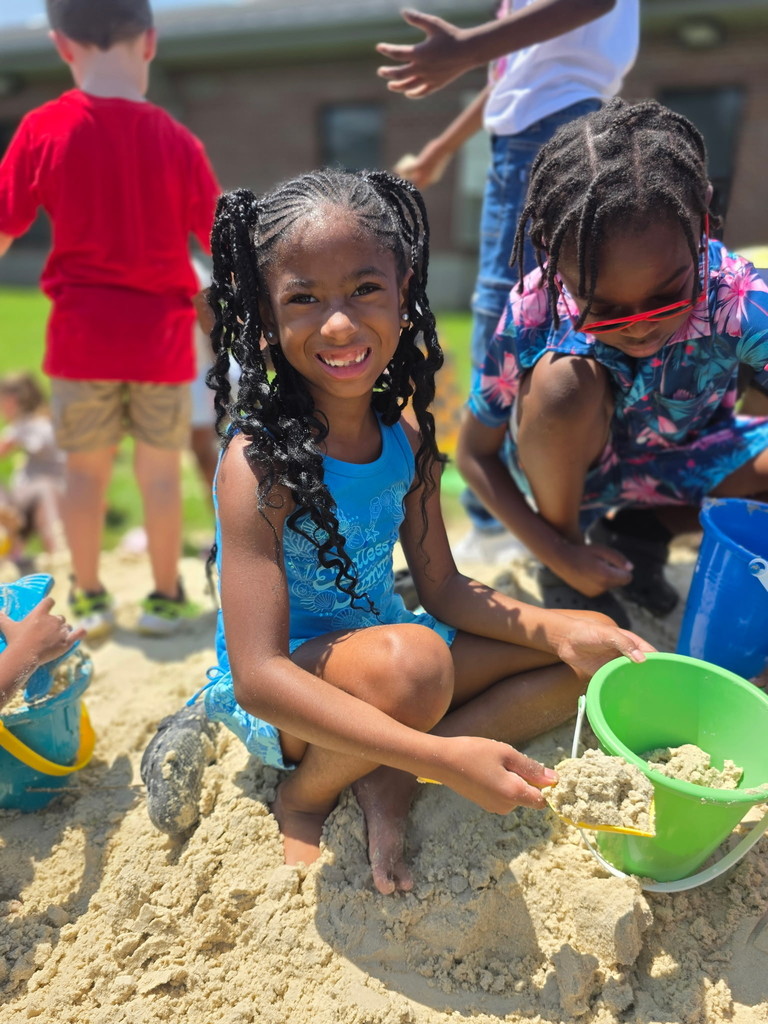 Students playing in the sand.