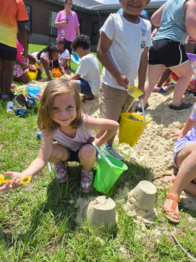 Students playing in the sand.