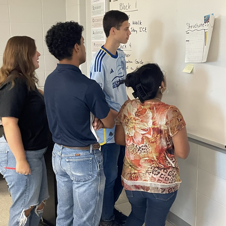 AP Lit students complete a gallery walk where they view their classmates' analysis of five skills using "The Yellow Wallpaper."