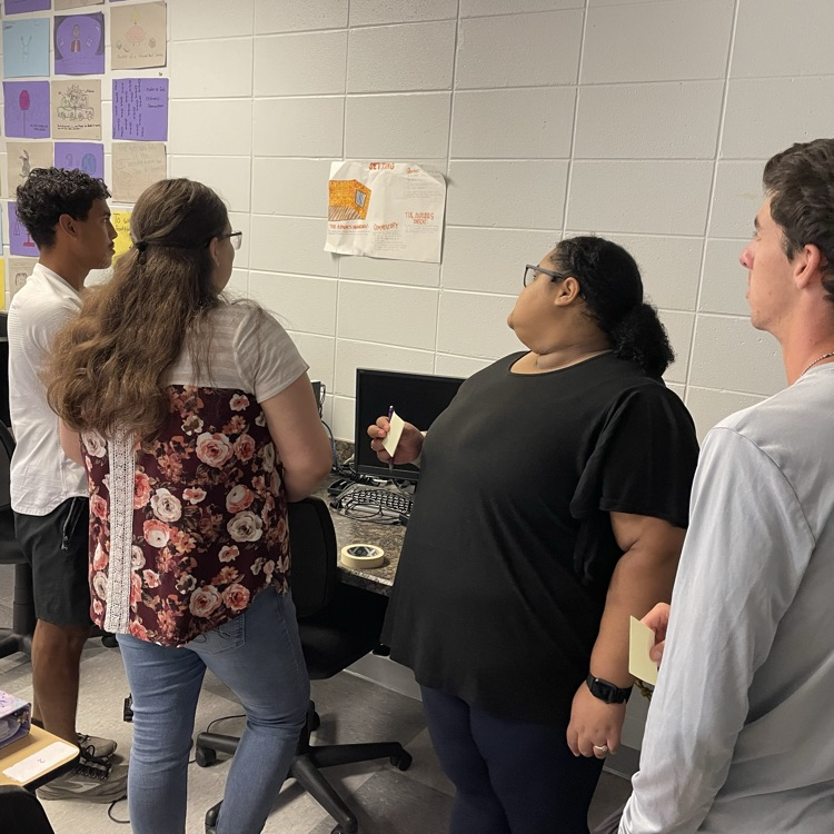 AP Lit students complete a gallery walk where they view their classmates' analysis of five skills using "The Yellow Wallpaper."