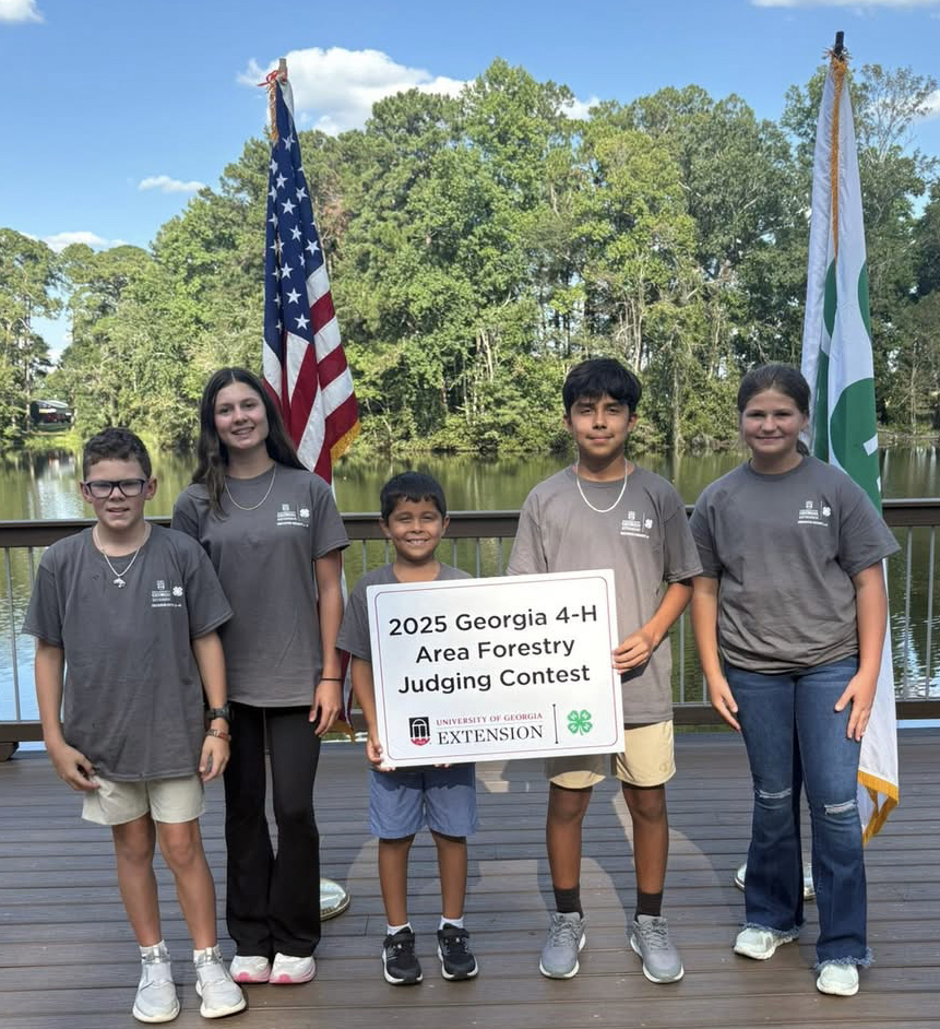 This image contains a picture of five students holding a 2025 Georgia 4-H Area forestry judging contest sign.