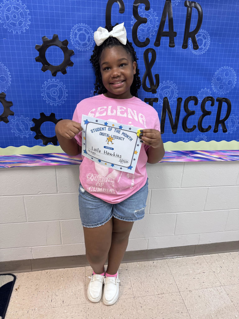 This image contains a picture of the student of month holding a certificate and a 3D token.