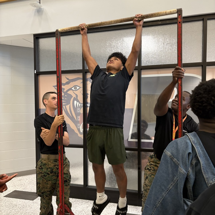 Marine recruiters spoke with students today and tested their strength on the pull-up bar. 
