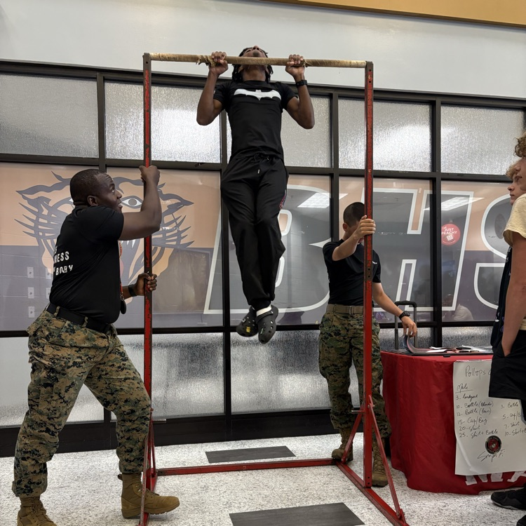 Marine recruiters spoke with students today and tested their strength on the pull-up bar. 