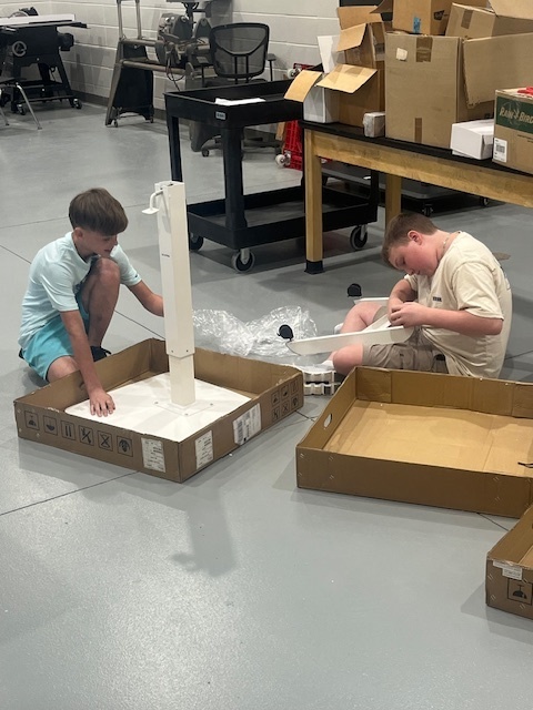 Mr. Cole's students helping to build desks for the school.