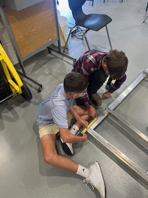 Mr. Cole's students helping to build desks for the school.