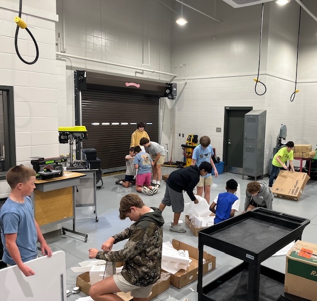 Mr. Cole's students helping to build desks for the school.