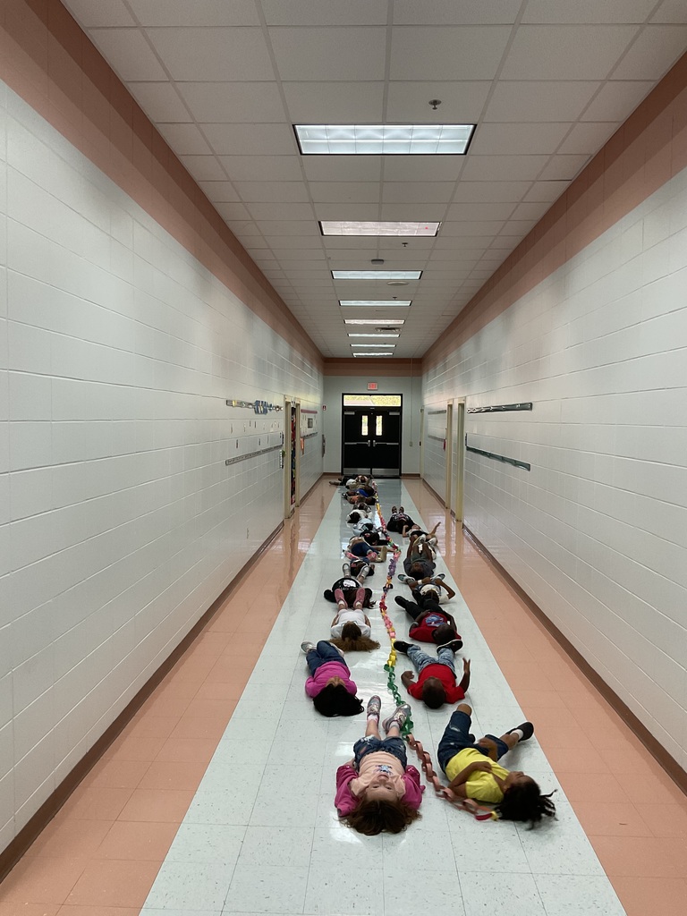 Picture of students laying on floor with their paper chain
