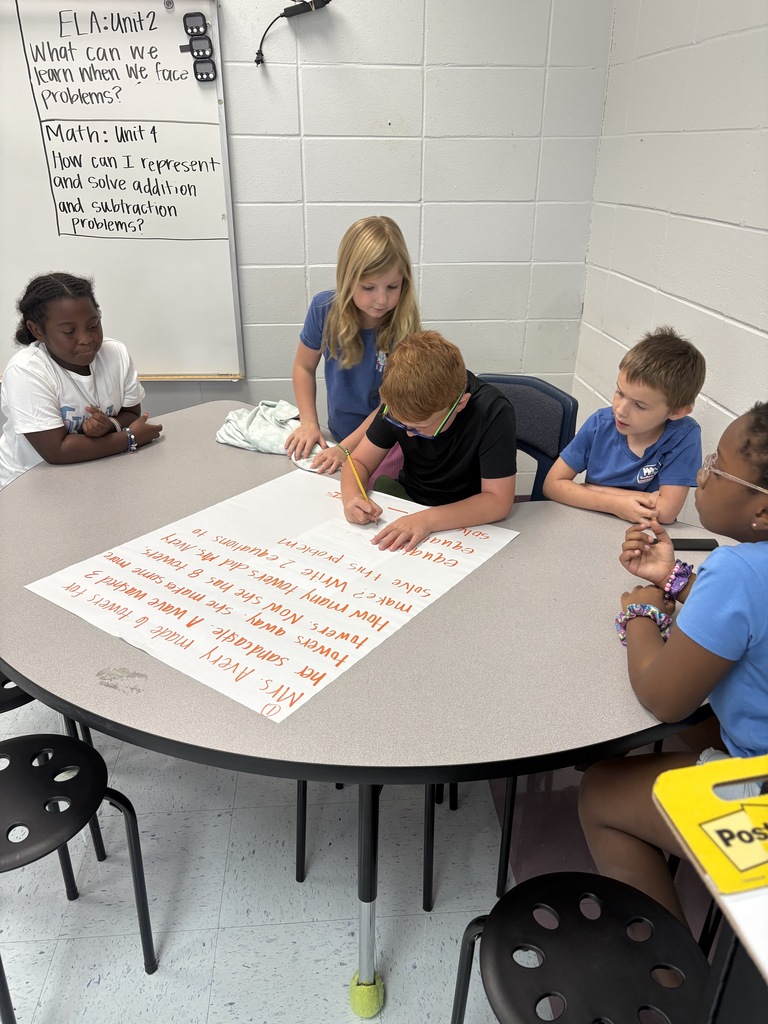 5 students working at a table