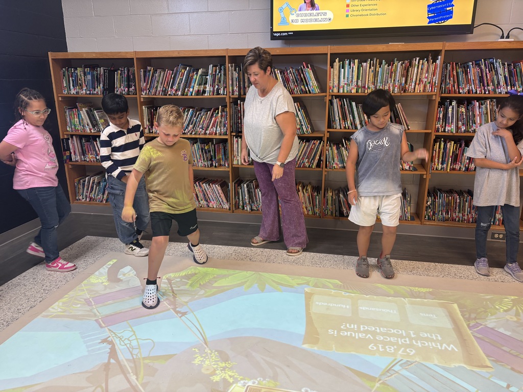 This image contains pictures of kids playing a math game on the active floor.