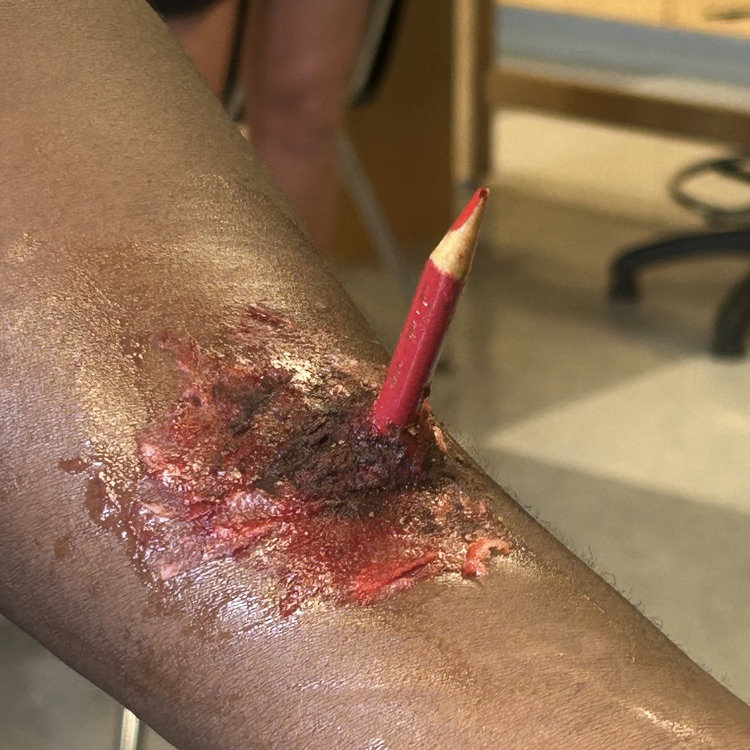 Anatomy students get ready for Halloween while learning about wound care. No injuries actually occurred