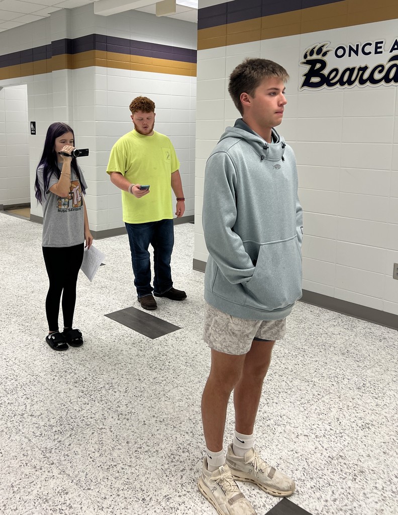 Student filming a tracking shot of another student.