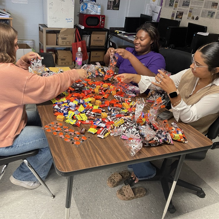 Anchor Club members Kenzie, Brooklynn and Jackie prepare goodie bags to deliver to the residents of Riverside Place on Thursday.
