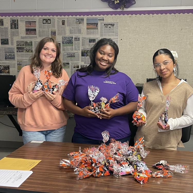 Anchor Club members Kenzie, Brooklynn and Jackie prepare goodie bags to deliver to the residents of Riverside Place on Thursday.