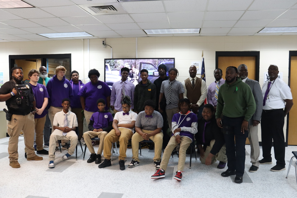 Group photo of the Tie Tuesday Gentlemen’s Club, community members, and mentors at New Beginnings Learning Center.