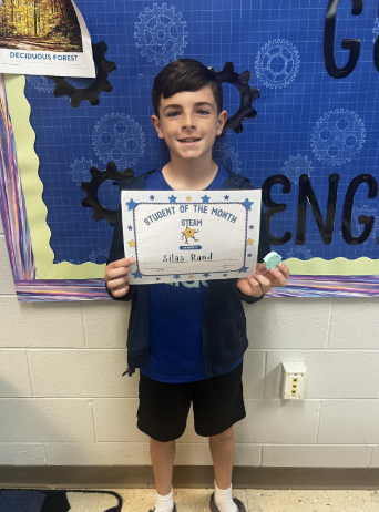 This image contains a picture a student holding a certificate.