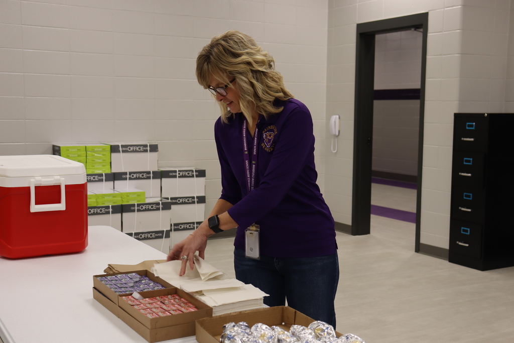 A BMS staff member prepares napkins and condiments for the Biscuits for the Best breakfast