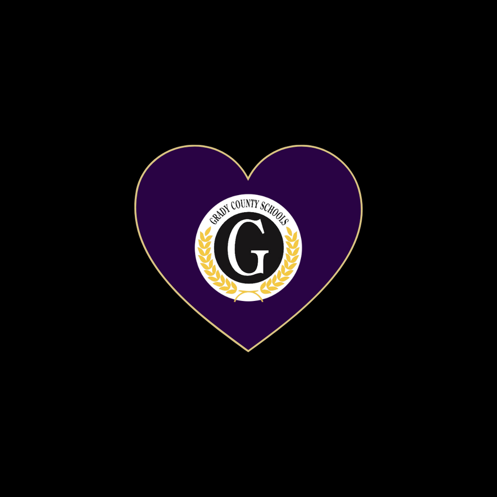 A purple heart outlined in gold with the Grady County Schools emblem in the center, featuring a black letter G surrounded by a gold laurel wreath on a white circle