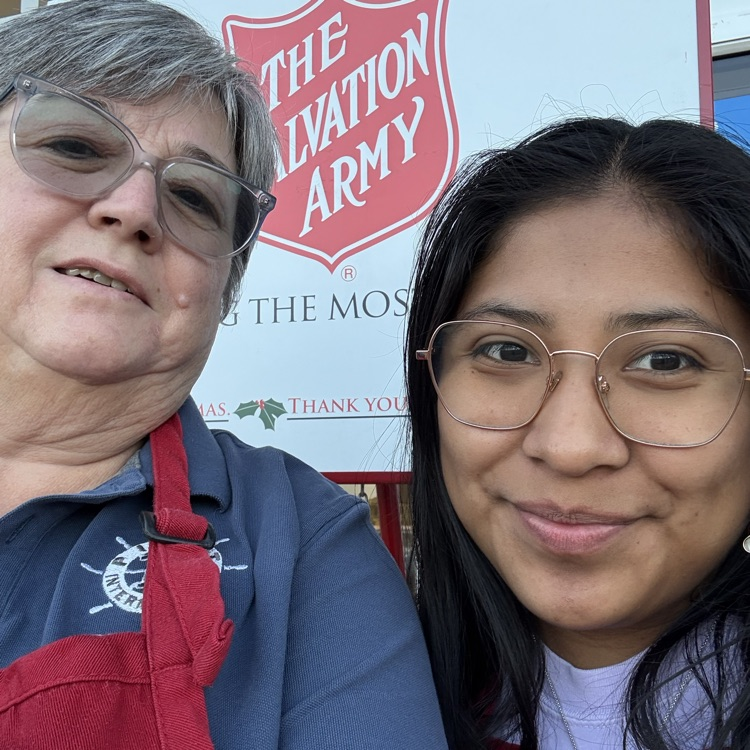 Anchor Angelica DeJesus fangs the Salvation Army bell with Pilot Missy Belcher.