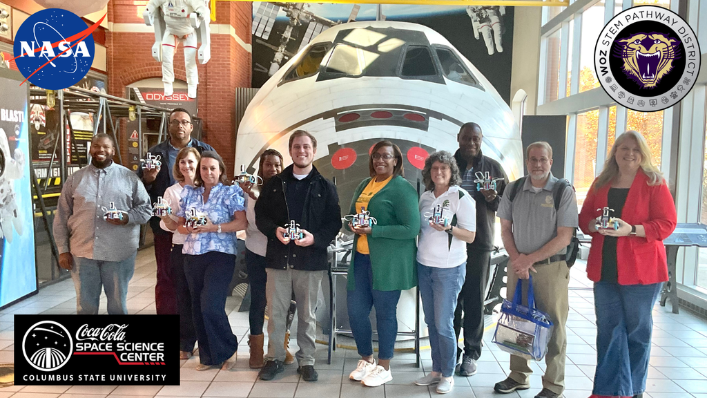 Educators from South West Georgia work at teh Coca Cola Space Science Center to learn more about using Spike Prime robots in all content areas. Pictured here with their robots and the space shuttle at the space science center in Columbus, GA