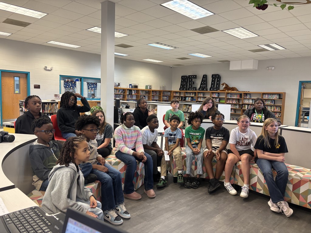Students in the media center at Hutto Elementary wait to ask questions as representatives of their school during this week's Direct to Discovery Session.