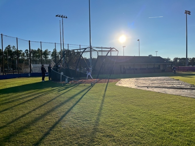 Hitting batting practice.
