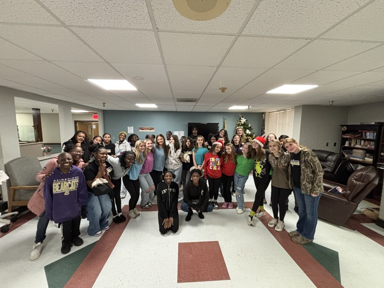 7th grade chorus students posed in front of a Christmas tree