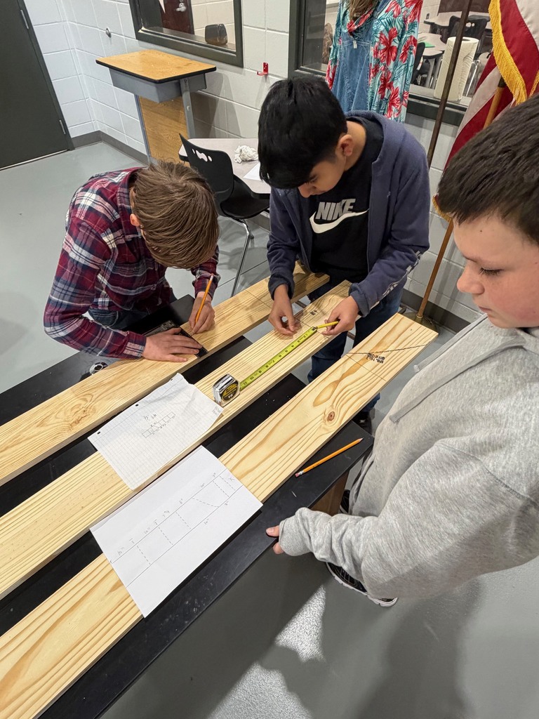 Students reading tape measures.