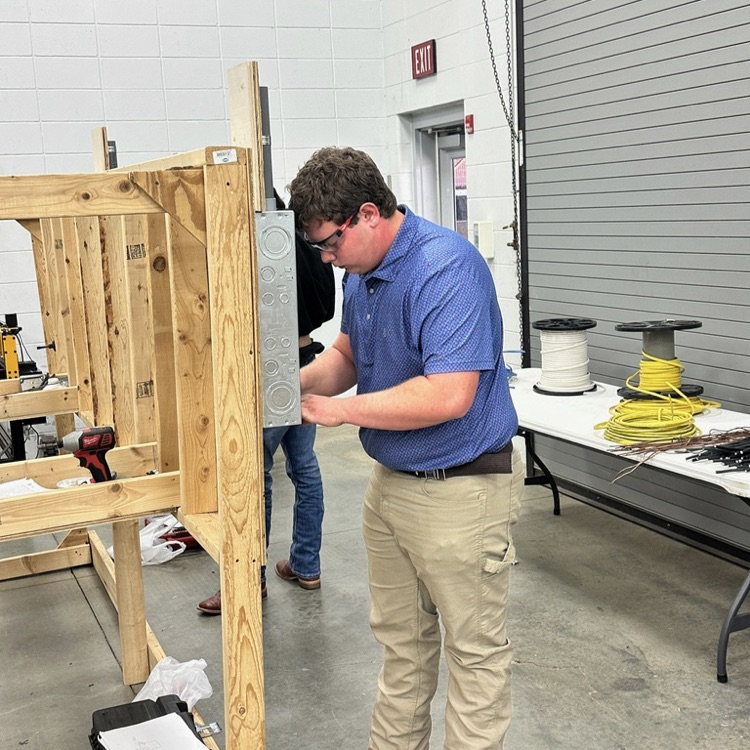Kevin Ray is wiring a circuit for the 2026 Area 5 EMC Wiring Contest.