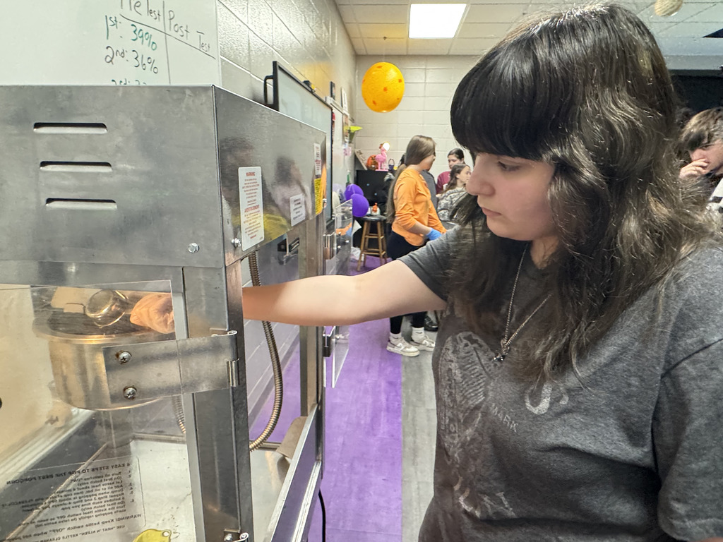 8th grade student works safely with a popcorn maker during Science lesson.