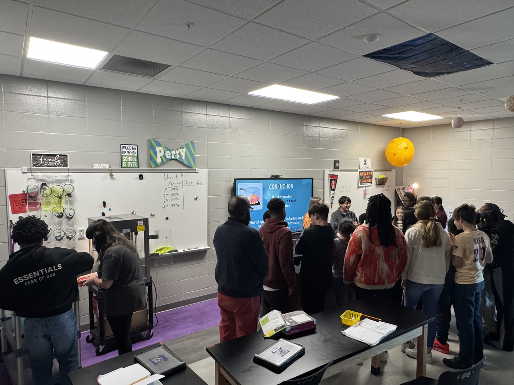 Students in multiple grades collaborating together.