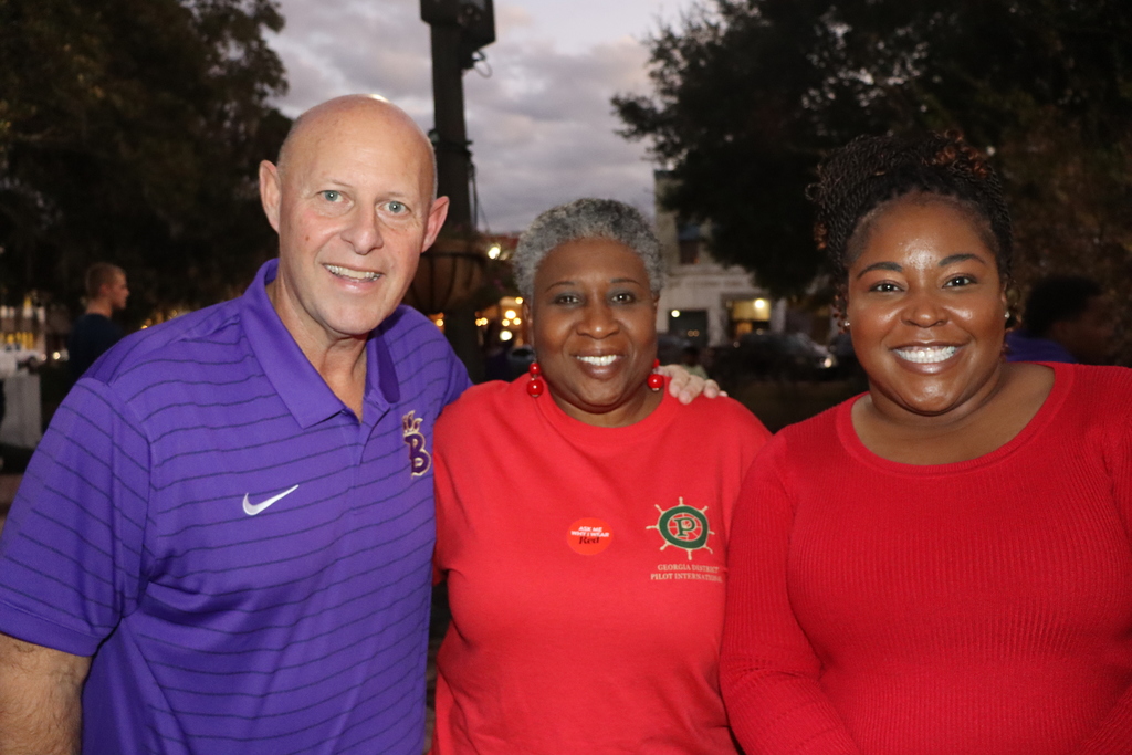 Coach Jamey DuBose poses with community members at the Meet and Greet event
