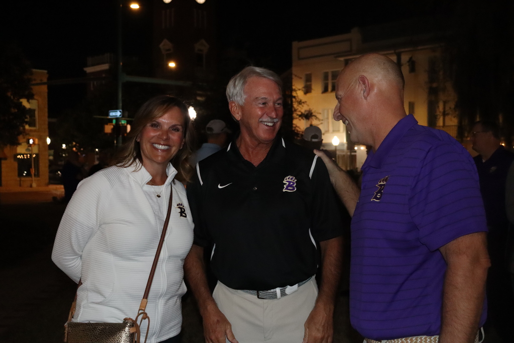 Coach Jamey DuBose poses with community members at the Meet and Greet event