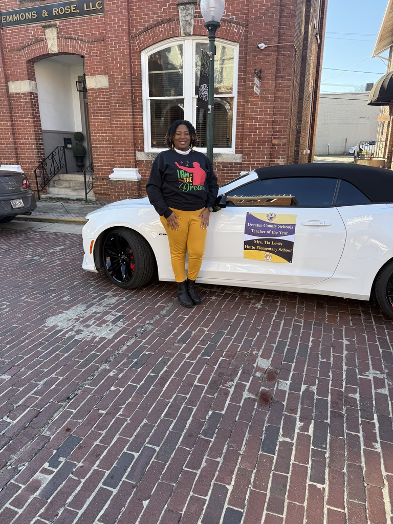 This image contains a picture of Mrs. Lewis the teacher of the year.