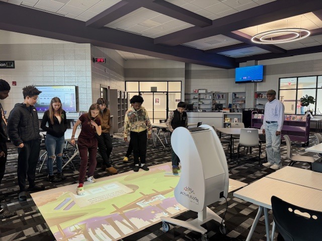 Students in 8th grade review what they have learned about waves using the interactive floor. 