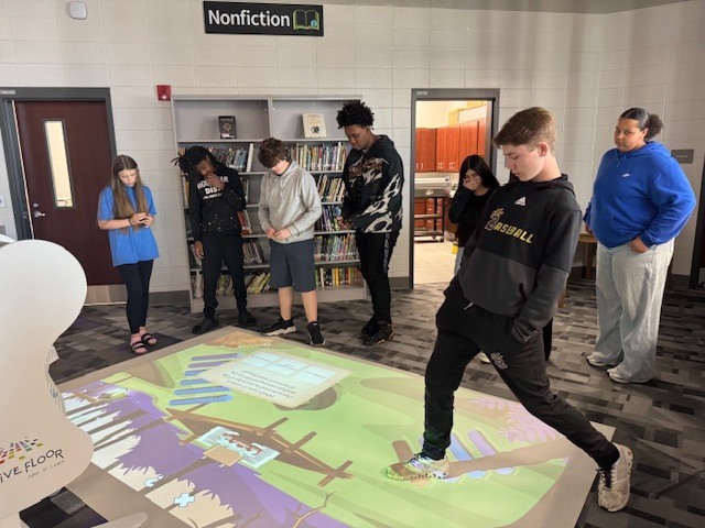 Students in 8th grade review what they have learned about waves using the interactive floor. 