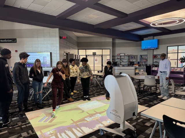 Students in 8th grade review what they have learned about waves using the interactive floor. 
