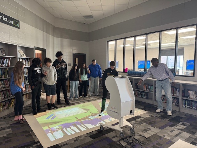 Students in 8th grade review what they have learned about waves using the interactive floor. 