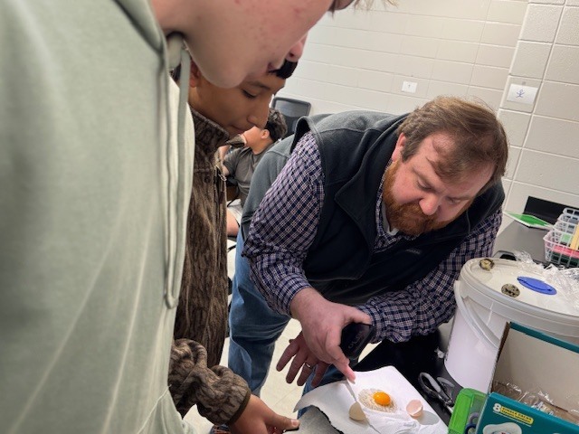 Stepping beyond the curriculum to embrace learning sparked by student choice, Ms. Rambo’s physical science class is incubating chicken and quail eggs as part of a hands-on exploration. One student extended the experience by bringing eggs from his own backyard coop, creating an authentic, real-world connection for his classmates. When questions surfaced, Mr. Cole stepped in to provide a mini-lesson on fertilized eggs and the incubation process, enriching the learning even further. Student voice. Real-world connections. Learning in action.