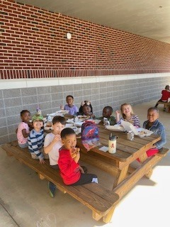 Mrs. Reynolds class enjoying beautiful weather for a picnic lunch