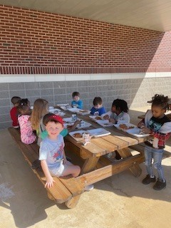 Mrs. Reynolds class enjoying beautiful weather for a picnic lunch