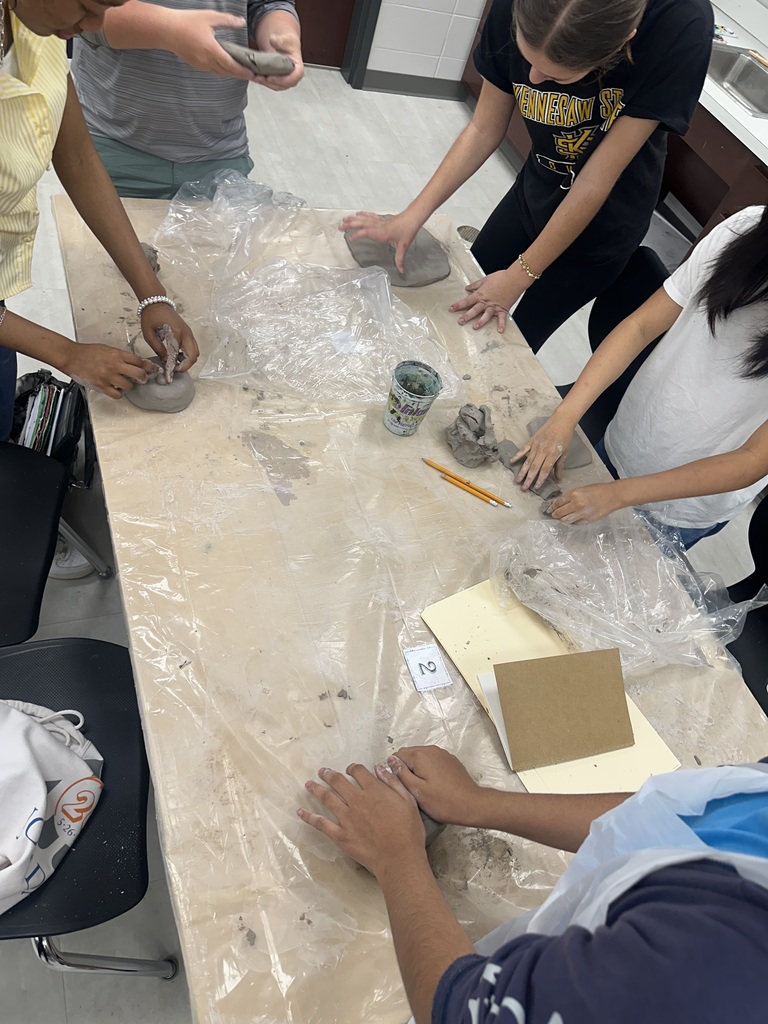 8th Grade students working with clay in Art Class.