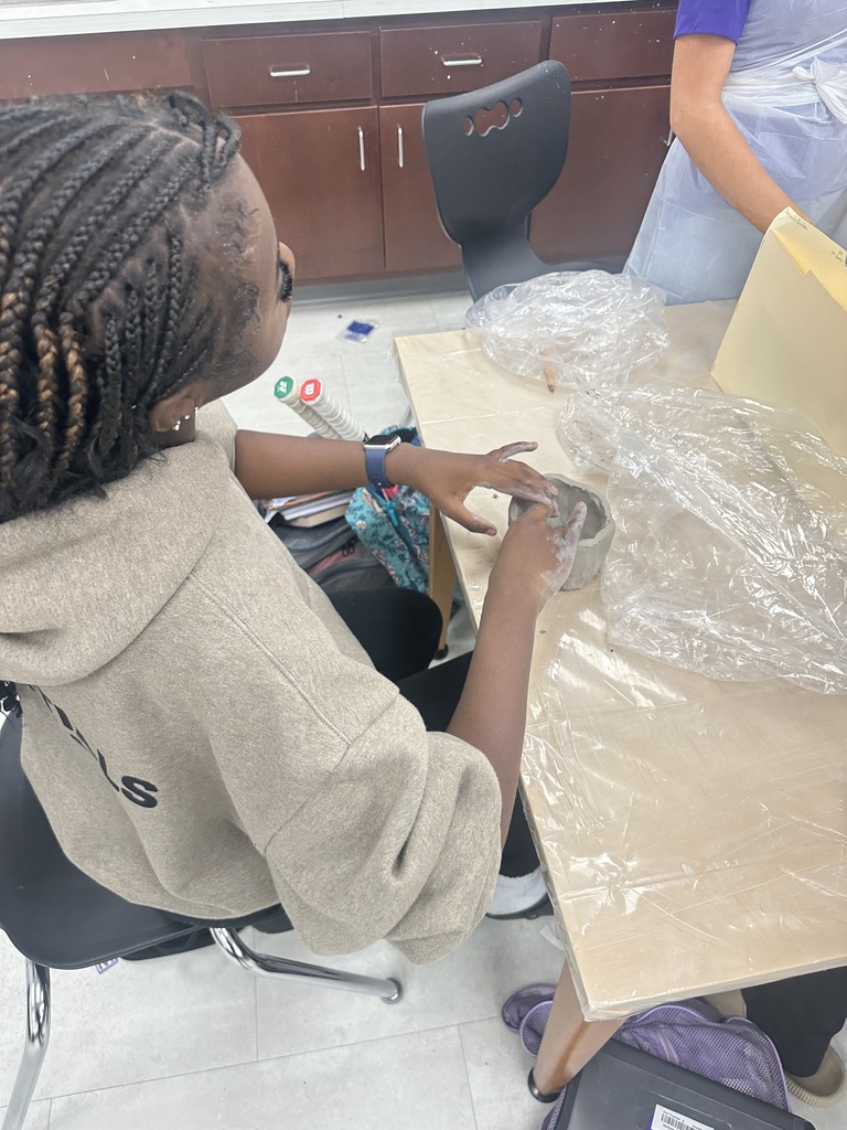 8th Grade student working with clay in Art Class.